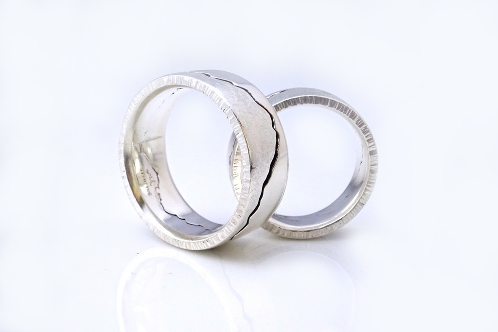 Silver mountain rings featuring hammered edges and comfort fit