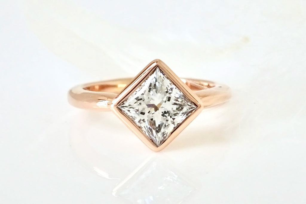 Close up view for a custom Princess Cut Diamond Solitaire Ring.  Made to order by goldsmith Michelle Lenáe in Seattle WA