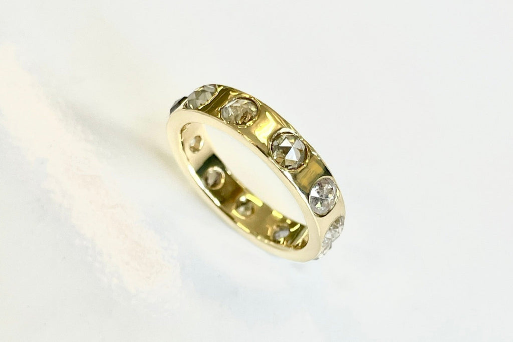 Side view of rose cut diamond eternity band showing bezel-set diamonds in continuous gold band – Michelle Lenae Jewelry custom design.
