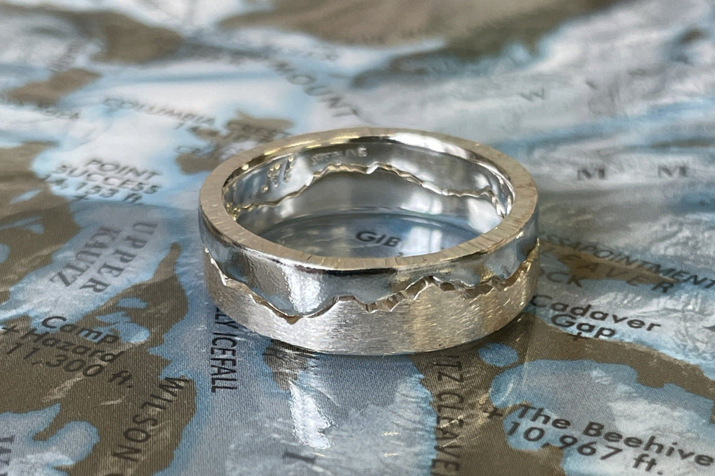 Interlocking Puzzle Mountain Ring handcrafted with your choice of recycle material and mountain range.  Each bespoke ring is handmade in Seattle WA. 