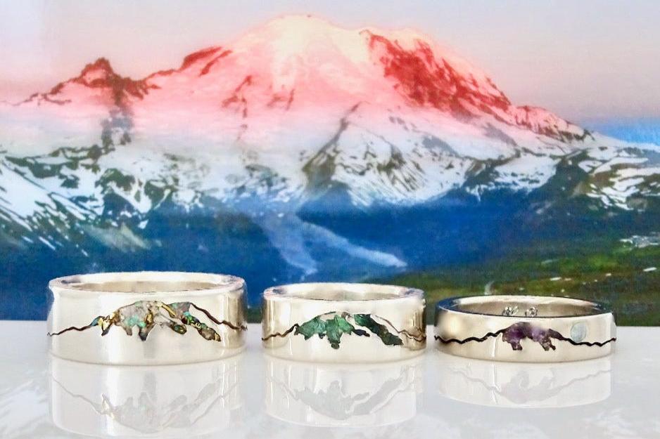 Side-by-side Rainier Mountain rings in 6, 7 and 8mm – handcrafted jewelry with customizable widths.