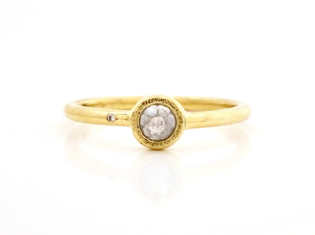 18k yellow gold solitaire with tiny diamond accent on one shoulder of round delicately hammered band,