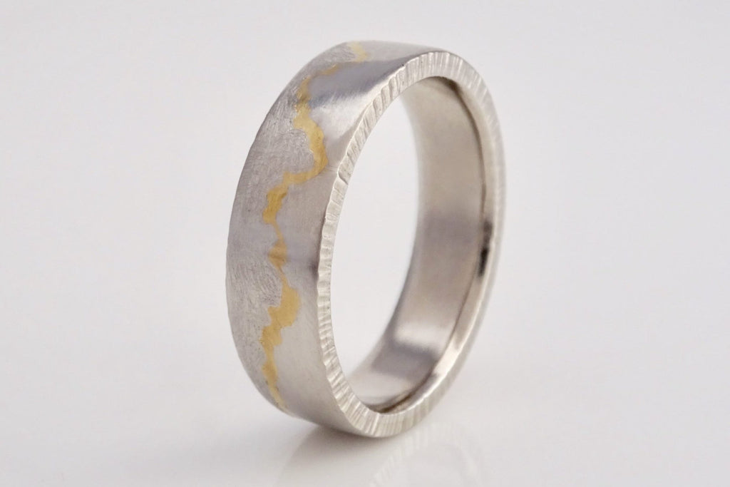 Kintsugi inspired gold inlay mountain ring featuring Grand Tetons.   Handcrafted in recycled platinum with 22k yellow gold inlay for the mountain silhouette